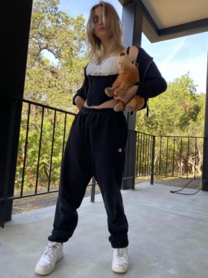 Sumski rocks Champion sweatpants and an underbust corset, combining athleisure and business casual in one, accessorizing with a capybara plushy.