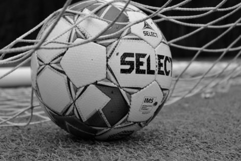 Soccer ball inside the net.
