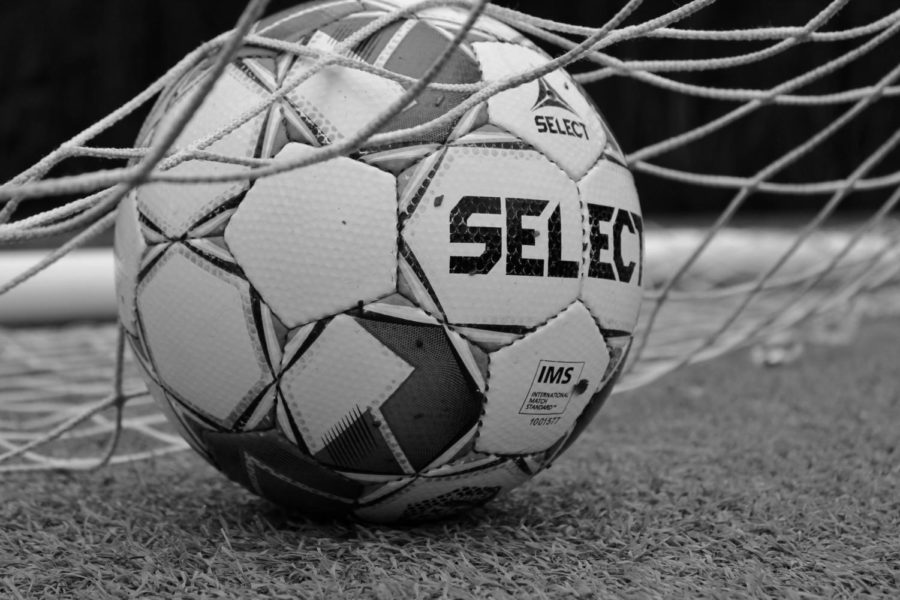 Soccer ball inside the net.
