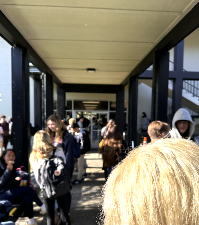 Outside of the upper school building, the busy hallways overflow beyond the inside walkways
